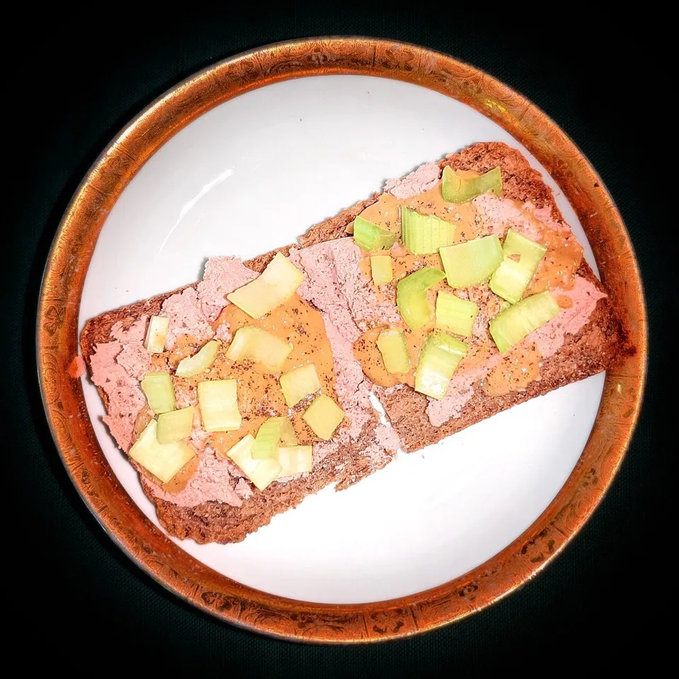 Liver pâté with mustard and pepper on grain bread