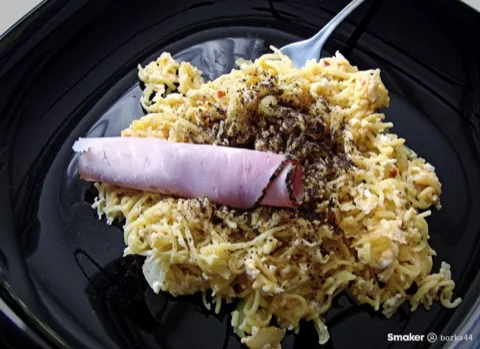 Fried leftover spaghetti with egg and a slice of ham